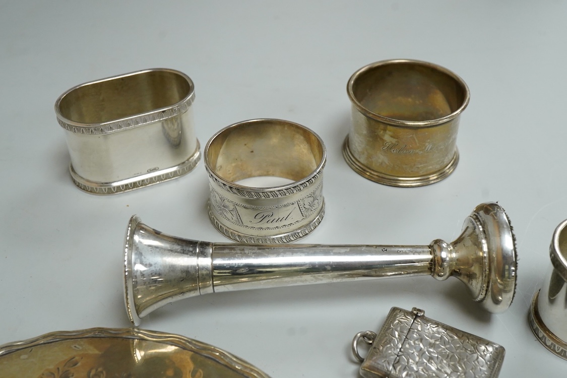 Three assorted silver napkin rings, a pair of recent 925 napkin rings, a George V silver mounted hand mirror, a modern silver mounted spill vase and a late Victorian silver vesta case.